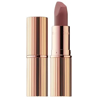 Charlotte Tilbury Matte Lipstick in signature packaging on a soft pink background