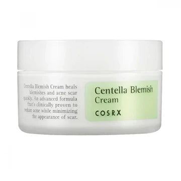 Close-up of COSRX Centella Blemish Cream jar with label text highlighting its blemish-healing properties. The product description emphasizes its advanced formula for treating acne scars and skin imperfections, featuring centella asiatica as the key active ingredient for skin recovery