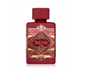 Red and gold perfume bottle with intricate design on a white background