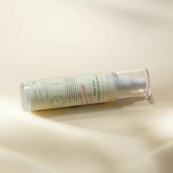 Model using AXIS-Y Glow Toner facial mist, showing fine spray absorbing quickly into skin for a refreshed, glowing look.