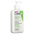 Close-up of creamy cleanser transforming into foam on fingertips during facial cleansing.