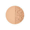 Model applying pressed powder with a brush for a natural touch-up look

