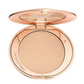 Refillable pressed powder compact opened to reveal ultra-fine product texture

