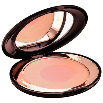Model applying blush to cheekbones using outer shade for sculpting

