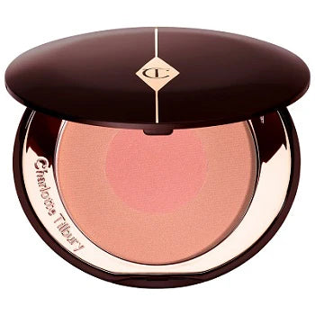 Model applying blush to cheekbones using outer shade for sculpting

