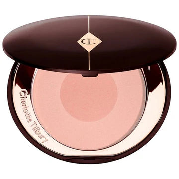 Makeup brush applying blush to cheek for a natural sculpted glow

