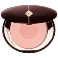 Makeup brush applying blush to cheek for a natural sculpted glow

