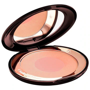 Makeup brush applying blush to cheek for a natural sculpted glow

