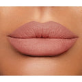 Swatches of Lip Cheat Lip Liner shades on the arm, ranging from nude to berry and red tones

