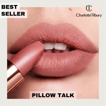 Model applying Pillow Talk Original lipstick with flawless skin and soft makeup

