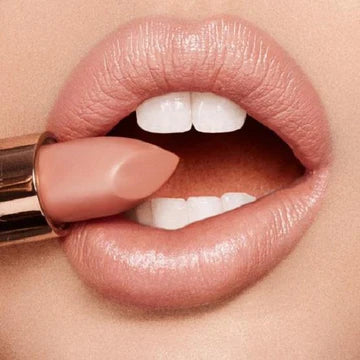 Model applying creamy K.I.S.S.I.N.G. lipstick with soft, radiant finish

