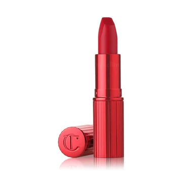 Close-up of model applying Charlotte Tilbury lipstick with square-angled tip

