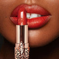 Hot Lips 2 lipstick range displayed in vibrant, refillable designer packaging

