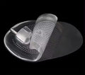 Transparent silicone foot pad with textured surface on a black background