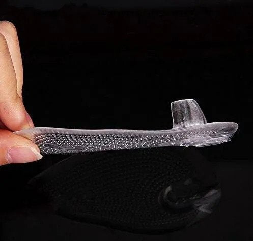 Clear orthotic insole held by a hand against a black background