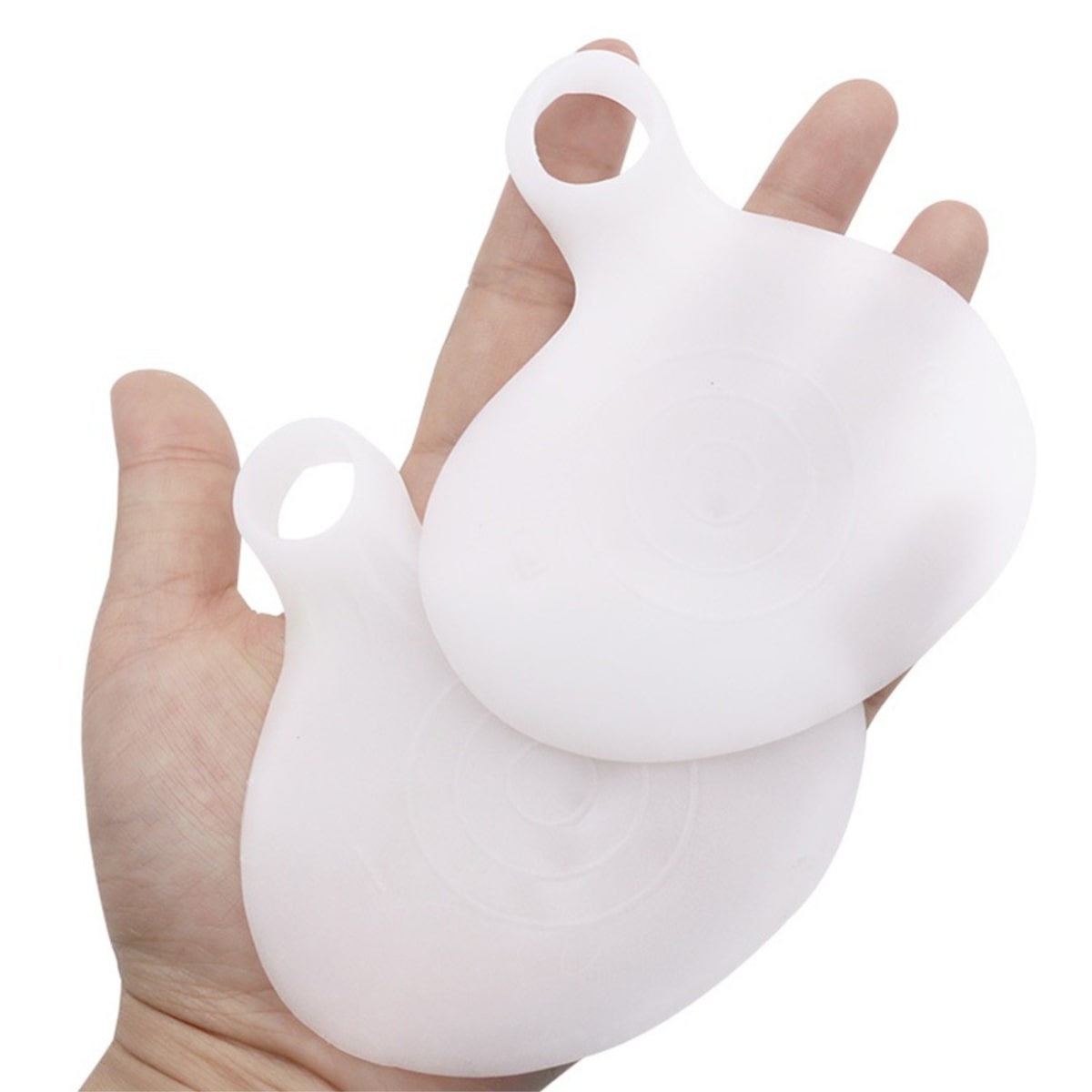 White silicone product held in a hand against a white background