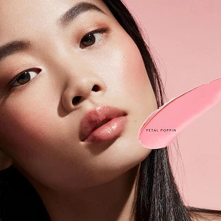 Model applying the cream blush, showing a natural, radiant flush on cheeks.

