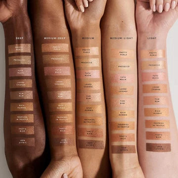 Highlighter swatch on various skin tones showing soft, natural glow.