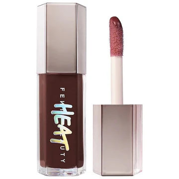 Swatch of gloss with luminous texture and soft rose tint on skin