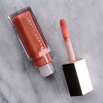 "Semi-Sheer to Medium Coverage Coral Lip Gloss with Hydrating Formula"

