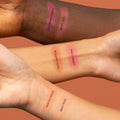 Swatches of Cheeky Vegan Blush Powder shades on diverse skin tones, showcasing buildable pigmentation in Charming Cherry, Berry Juicy, Sassy Saffron, Caring Coral, Healthy Peach, and Milky Rose for a natural, radiant finish