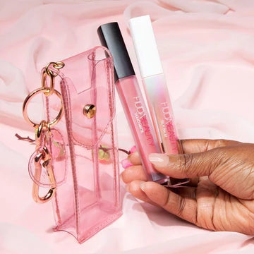 Huda Beauty Cherry Blossom Lip Set packaging showing floral pouch with Lucky 04 liquid lipstick and shimmering Silk Balm