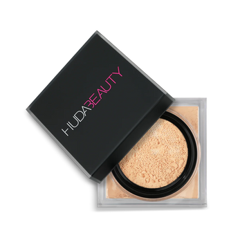 HUDA BEAUTY Easy Bake Loose Powder packaging in Banana Bread, showcasing product labels like 'Easy Bake Family,' 'Easy Bake & Snatch,' and 'Easy Bake Mini' with brand name and variant details.
