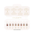 Huda Beauty's KAYALI Discovery Layering Set showcasing eight luxury perfume miniatures (1.5ml each) with their signature scent notes displayed. The elegant packaging highlights fragrances like Vanilla 28, Lovefest Burning Cherry 48, and Yum Pistachio Gelato 33, featuring gourmand, floral, and spicy accords for customizable scent combinations