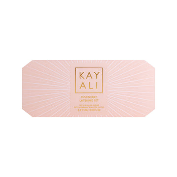 Huda Beauty's KAYALI Discovery Layering Set featuring 8 luxury perfume miniatures (1.5ml each) for creating custom fragrance combinations. The sleek packaging displays the brand's elegant typography with 'KAYALI' prominently featured.