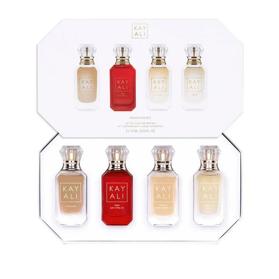 Four KAYALI 10ml mini perfumes in gold-capped bottles (Vanilla 28, Juicy Apple 01, White Flower 57, Amber 23) displayed with minimalist brandingFour KAYALI 10ml mini perfumes in gold-capped bottles (Vanilla 28, Juicy Apple 01, White Flower 57, Amber 23) displayed with minimalist branding