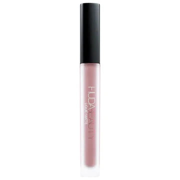 Four mini HUDA BEAUTY Liquid Matte Lipsticks in grunge-inspired nude shades (Bombshell, Rebel, Maverick, Sweet Talker) with transfer-proof, 8-hour wear formula