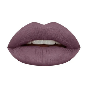 Four mini HUDA BEAUTY Liquid Matte Lipsticks in grunge-inspired nude shades (Bombshell, Rebel, Maverick, Sweet Talker) with transfer-proof, 8-hour wear formula