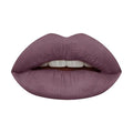 HUDA BEAUTY Pretty Grunge Liquid Matte Lipstick Mini Quad featuring four long-wear shades: Bombshell (warm brown), Rebel (terracotta), Maverick (honey beige), and Sweet Talker (pinky brown). Shows the sleek packaging and open tubes with doe-foot applicators for precise matte application