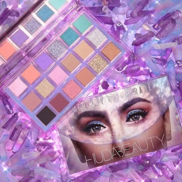 HUDA BEAUTY Mercury Retrograde Eyeshadow Palette showcasing 18 shades including 9 mattes, 6 metallics, 1 glitter, and 2 multi-reflective toppers for celestial makeup looks
