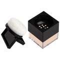 HUDA BEAUTY Mini Easy Bake Loose Powder in Poundcake shade - small round compact with gold lid and black base
