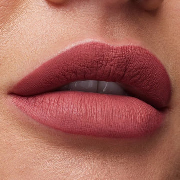 Close-up of Huda Beauty Must-Have Minis Lip & Eye Set showing the collection's logo and gold-accented packaging