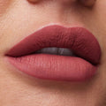 Huda Beauty Must-Have Minis Set featuring mini Legit Lashes mascara, Quick 'N Easy liquid liner, and Liquid Matte lipstick in Bombshell – travel-sized luxury makeup essentials.