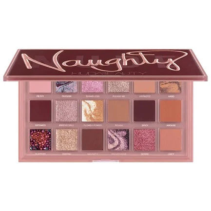 Naughty Nude Eyeshadow Palette by HUDA BEAUTY displaying nine neutral shades from light beige to deep bronze with their names: ROUGH, SHOY, AROUGE, SUPPERLY, TAKING, MUDNITY, PROVOCATIVE, GESTIVE, and LUCKY