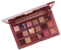 Close-up of HUDA BEAUTY's Naughty Nude Palette showing nine eyeshadows named FILTHY, PASSION, SNAMBLESIS, PLEASE ME, HYPNOTIC, HARD, QUIVANED, IRRESISTIBLE, and FLOWER POWER in neutral tones