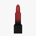 Close-up of Huda Beauty Power Bullet Lipstick tube with metallic bullet design, showcasing blood red’s bold color