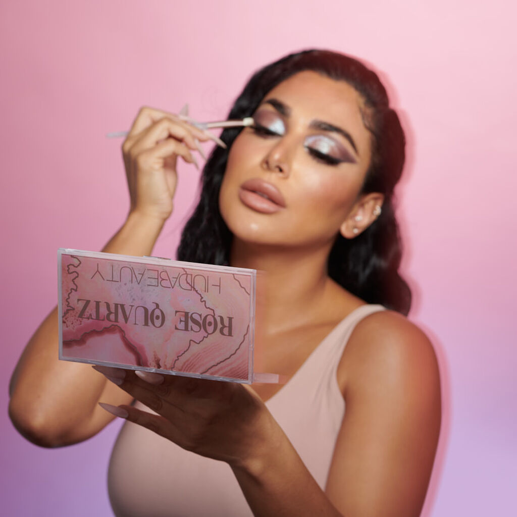 Open Rose Quartz Eyeshadow Palette featuring 18 shades in a mix of matte, metallic, shimmer, and marbled finishes arranged in a luxurious pink-toned case with a crystal-inspired lid design.