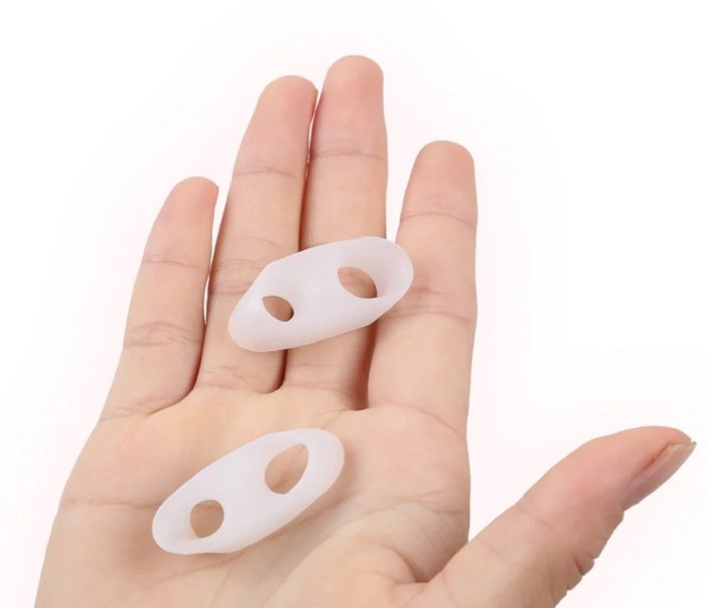 Bunion correctors on a foot with a white background
