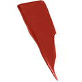 Hand holding SuperStay Matte Ink lipstick with applicator dipped in a bold maroon shade

