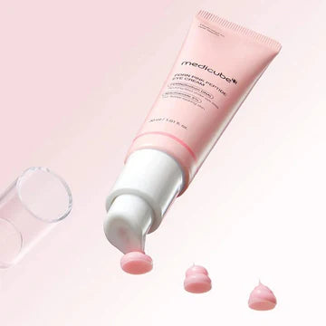 Pink skincare product with white cap on a light pink background