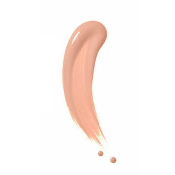 Model applying foundation with a makeup sponge for smooth coverage

