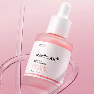 Medicube serum bottle on a pink background