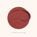 Close-up of Soft Pinch Lip Oil applicator showing glossy rose brown tint.

