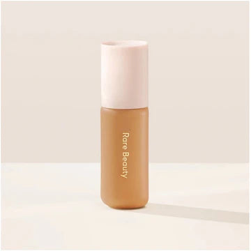 Model applying tinted moisturizer using fingers for a quick, natural look.

