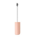 Close-up of applicator tip dispensing the brightener on skin.


