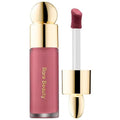 Liquid blush applicator dispensing a drop of product onto a makeup brush with a soft background.

